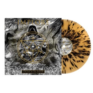 Op de afbeelding: Een zwart-witte vinylplaat met een goud-zwart geometrisch ontwerp. De plaat is getiteld "A Decade in the Shadow" en heeft de bandnaam "IMPLORE" in gouden letters.