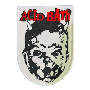 May include: A white patch with a black and white illustration of a face with horns. The red text "ACID BATH" is arched above the face. The patch has a stitched border.