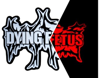 May include: A black and white Dying Fetus logo with a distinctive, stylized design. The logo is set against a white background on the left and a red glowing version on a black background on the right.