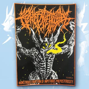 May include: Black patch with an orange border featuring a white and black illustration of a three-eyed demon with horns. The demon is exhaling yellow flames. The patch has the text "MONSTROUS ERUPTION OF IMPETUOUS PREPOSTEROSITY".