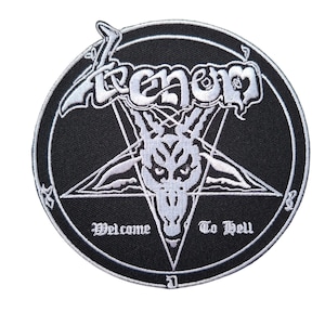 May include: Black circular patch with white embroidered text and imagery. The word "Venom" is at the top, above a white pentagram with a goat's head. The text "Welcome To Hell" is at the bottom.