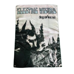 May include: A rectangular fabric wall banner featuring the text Electric Wizard and Dopethrone in black and light blue lettering. The graphic design displays a high-contrast black and white image of a horned figure amidst dark, smoky silhouettes.