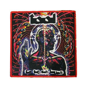 May include: Square patch with a black background and a red border. The patch features a stylized illustration of a human figure with a glowing spine and a halo. The word "TOOL" is at the top, and "Lateralus" is at the bottom.