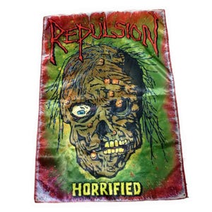 May include: A banner with a zombie graphic. The banner features the word "REPULSION" in red, stylized lettering at the top, and the word "HORRIFIED" in yellow at the bottom. The zombie has a green and brown color scheme.
