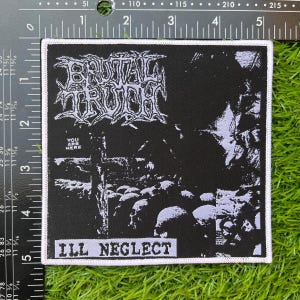 May include: A black and white patch featuring the band name "BRUTAL TRUTH" in a gothic style font. The patch depicts a graveyard scene with skulls and a cross. The text "YOU ARE HERE" and "ILL NEGLECT" are also present.