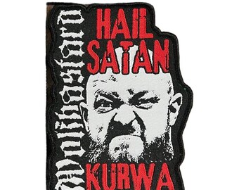 May include: Black and white patch with the text "Hail Satan Kurwa" in red and white. The patch features a stern, illustrated face. The word "Defiant" is written vertically on the left side of the patch.