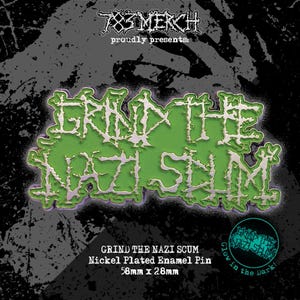 May include: A green and white enamel pin with the text "GRIND THE NAZI SCUM". The pin is nickel plated and glows in the dark. The pin measures 58mm x 28mm.