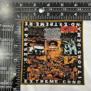 May include: Square patch with a black border featuring a collage of images in shades of orange, brown, and green. The patch has text that reads "NO EXTREME CONDITIONS DEMANDS RESPONSES" and "BRUTAL TRUTH". The patch is approximately 7.6 cm by 7.6 cm.
