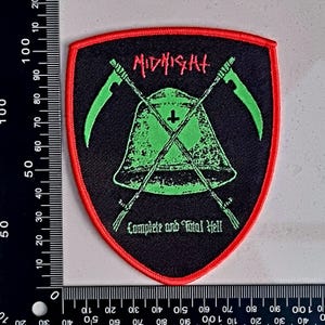 May include: Black and green embroidered patch with a red border. The patch features a bell with a cross on top, two crossed scythes, and the text "MIDNIGHT" and "Complete and Total Hell".