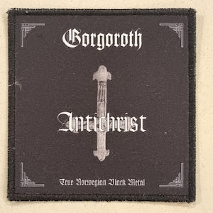 May include: Black square patch featuring the band name "Gorgoroth" and the word "Antichrist" in white gothic lettering. A silver cross is centered. The text "True Norwegian Black Metal" is at the bottom.