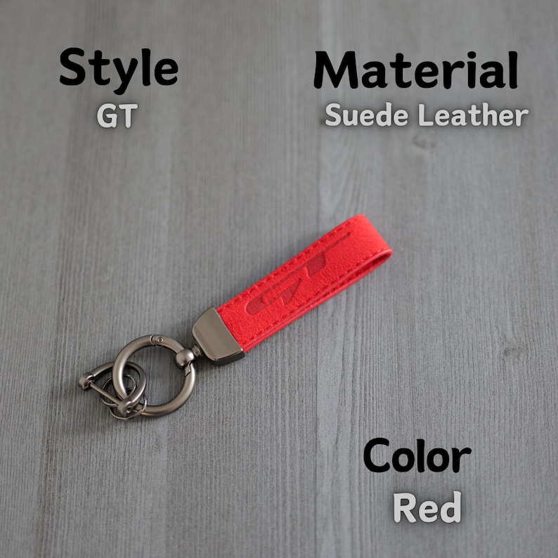 May include: Red suede leather keyring with a silver key ring and the word "GT" embossed on the leather.