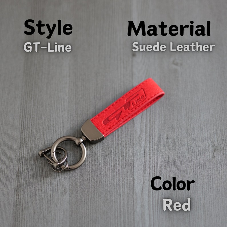 May include: Red suede leather keychain with a silver ring and a GT-Line logo.