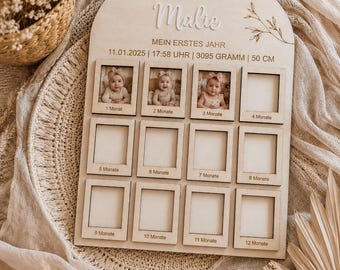 May include: An arched wooden baby milestone board featuring the name Malie, birth details including 11.01.2025, 17:58, 3095 grams, and 50 cm, with twelve square photo frames labeled 1 Monat through 12 Monate, three of which contain baby photos.