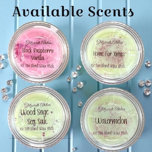 May include: Four wax melt containers with the text "Available Scents." The scents are Black Raspberry Vanilla, Home For Xmas, Wood Sage + Sea Salt, and Watermelon. Each container is 1 oz soy blend wax melt.
