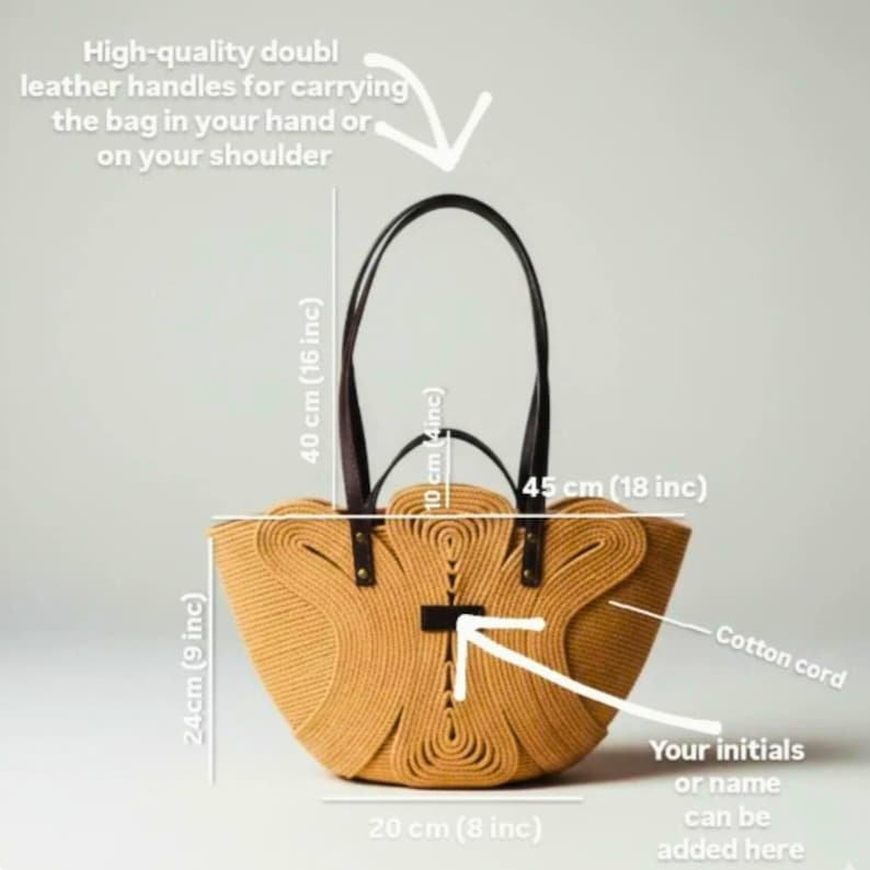 May include: A woven straw tote bag with brown leather handles. The bag is 18 inches wide, 9 inches tall, and 8 inches deep. The handles are 16 inches tall. The bag features a cotton cord design and space for initials.