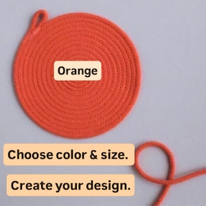 May include: A circular orange woven item with a loop, possibly a coaster or trivet. The word "Orange" is displayed on the item. Text below reads "Choose color & size." and "Create your design."