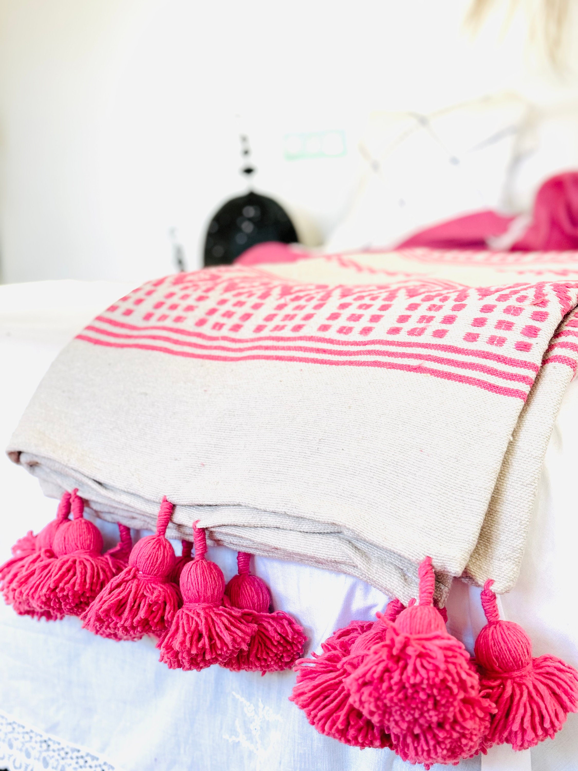 Moroccan Blanket, a wool blanket with Moroccan pompoms, handmade at Telares de Tanger. Designed by Azul Turquesa Home.