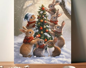 May include: A group of brown rabbits wearing red and green scarves decorate a Christmas tree with red and gold ornaments. The tree is covered in snow and the rabbits are standing on a snowy background.