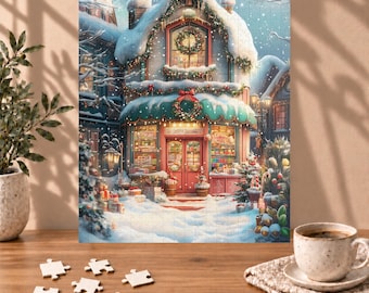 May include: A jigsaw puzzle depicting a snow-covered storefront during winter, featuring a red door, festive wreaths, and glowing windows. The scene includes falling snow, decorated trees, and gift boxes, with several loose puzzle pieces on a wooden table.
