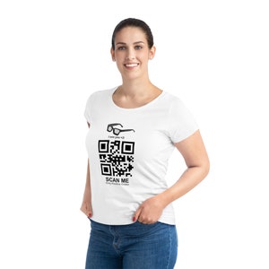 May include: White t-shirt with a black and white QR code that says "SCAN ME Only Positive Codes" and a pair of glasses above the code that says "I see you <3"