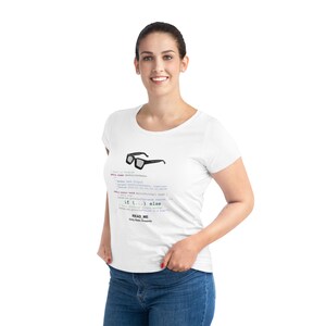 Puede incluir: Camiseta blanca con un diseño de gafas 3D y líneas de código. El texto "READ ME" y "Only Static Snapshots" están impresos debajo. La camiseta es de cuello redondo.