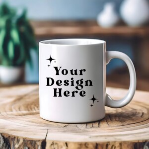 May include: White ceramic mug with a black design that says "Your Design Here" with two small stars on either side of the text.
