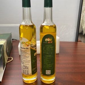 two glass bottles of camellia. oil