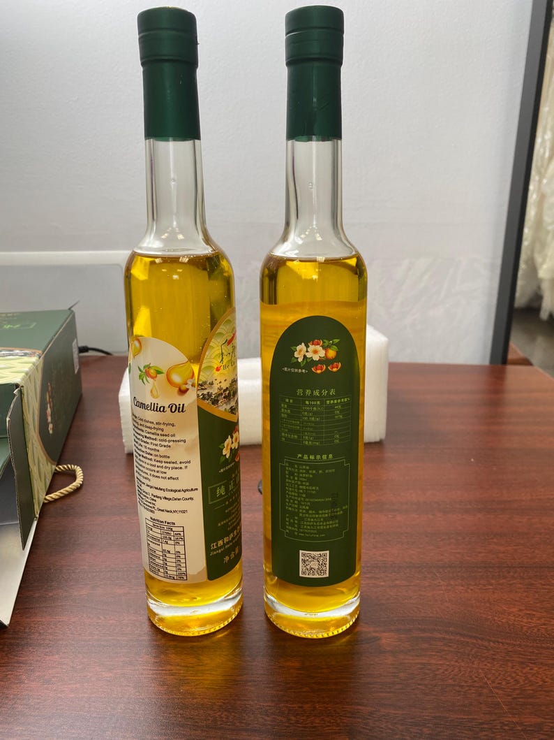 two glass bottles of camellia. oil
