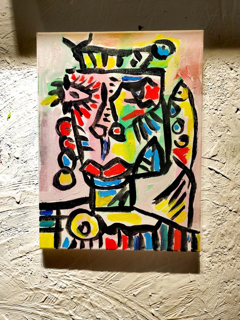 Puede incluir: Pintura abstracta de una cara con l&iacute;neas negras audaces y colores brillantes, incluyendo rosa, rojo, amarillo, verde y azul.