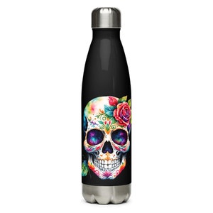 May include: Black insulated water bottle with a colourful sugar skull design. The skull features floral accents, including a red rose and intricate patterns. The bottle has a silver cap and base.