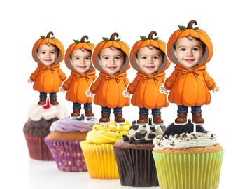 May include: Six orange pumpkin cupcake toppers with a child's face in the center of each pumpkin. The toppers are on top of cupcakes with different colored frosting and sprinkles.