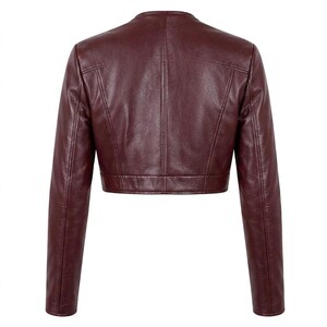 Back view of the burgundy leather cropped jacket laid flat against a white background.