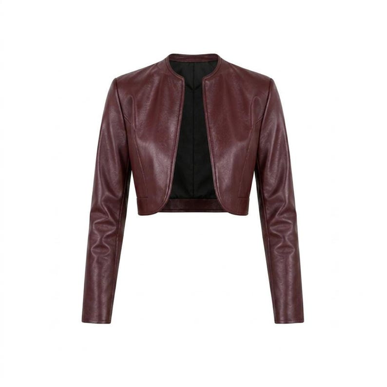 Front view of a burgundy leather collarless cropped jacket laid flat against a white background.
