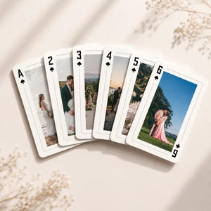 May include: A fan of six playing cards featuring the spade suit, labeled A through 6. Each card displays a unique full-color wedding photograph of a couple in various outdoor settings, including beaches, landscapes, and grassy fields.