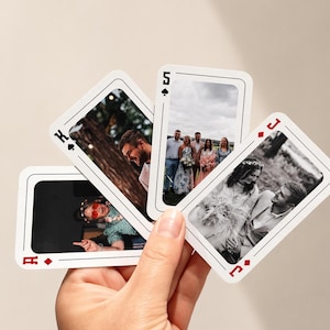 Hand holding personalised photo playing cards featuring custom wedding photos