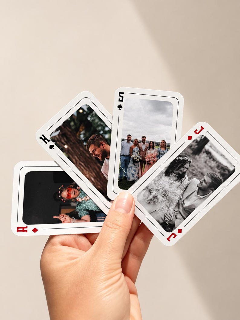Hand holding personalised photo playing cards featuring custom wedding photos