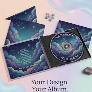 May include: A CD case with a CD inside, featuring a design of a starry night sky with clouds in shades of blue, purple, and pink. The CD case is open, displaying the CD with the text "YOUR DESIGN. YOUR ALBUM." The back of the case lists song titles.