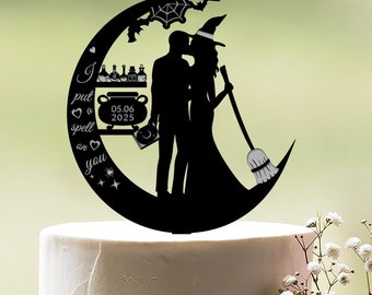 May include: Black silhouette of a bride and groom kissing on a crescent moon with a broom, cauldron, and potion bottles. The text reads "I put a spell on you" with a heart and spider. The date 05.06.2025 is also included. This is a wedding cake topper.