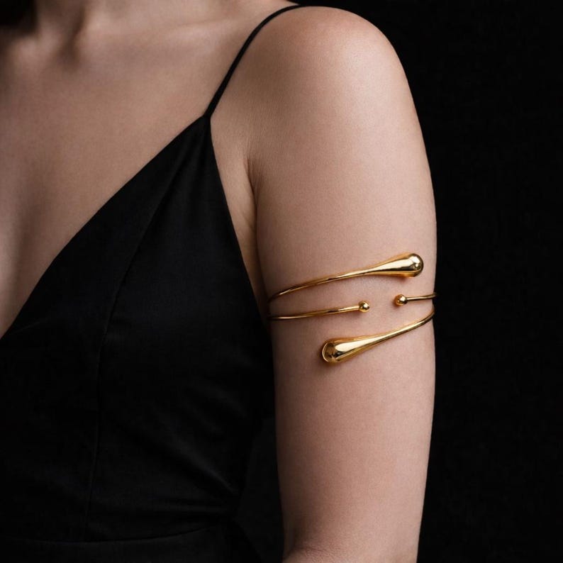 Bold gold armlet that instantly upgrades your outfit with modern elegance. Comfortable adjustable upper arm cuff—designed to fit beautifully and stand out.