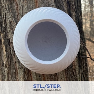May include: A white birdhouse with a textured surface and a round opening. The birdhouse is mounted on a tree trunk.