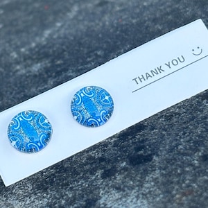 May include: A pair of blue and white patterned earrings on a white card with the text "THANK YOU" and a smiley face.