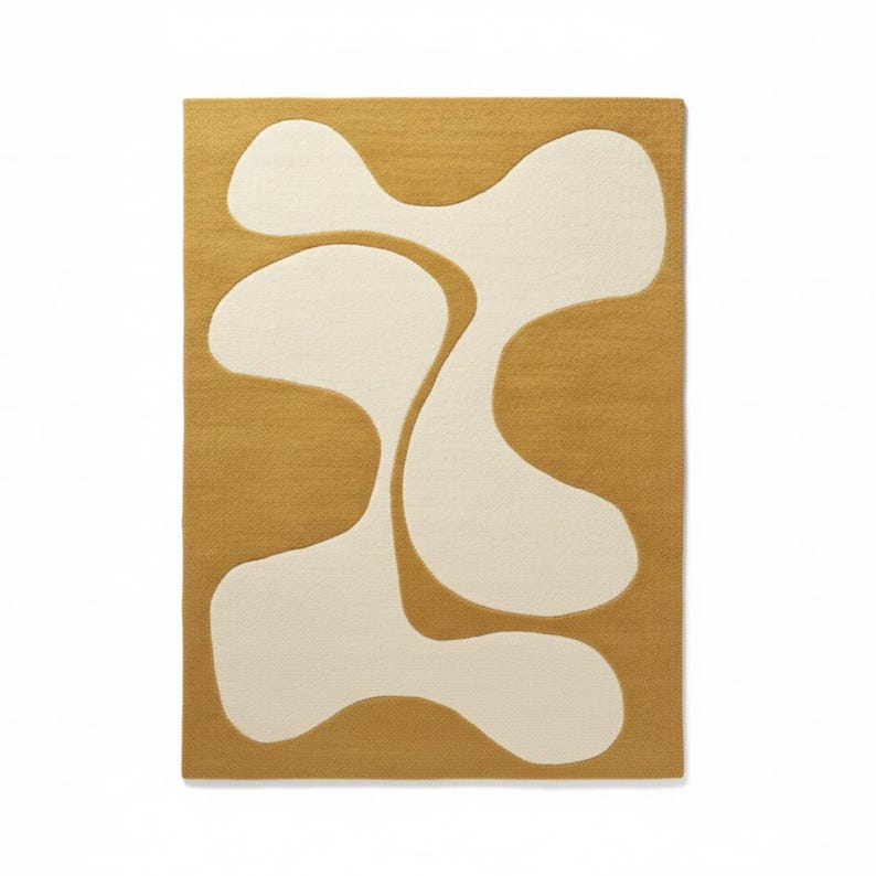 May include: A rectangular rug with a mustard yellow background and a large, abstract design in off-white. The design features interconnected, organic shapes, creating a modern and artistic aesthetic. The rug is likely made of a soft, textured material.