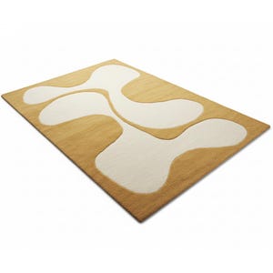 May include: A rectangular rug with a light brown background and large, abstract white shapes. The rug has a soft, textured appearance and a modern design. The rug is angled, showing its thickness and the contrast between the colors.