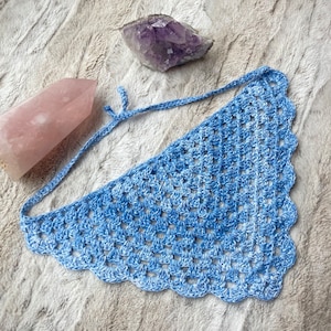 Detailed view of the handmade crochet work on the Aphrodite Shell Hair Bandana, highlighting the fine craftsmanship and unique shell edge. The color option is Bluebell, a multi-shade blue triangle with matching edging and ties.