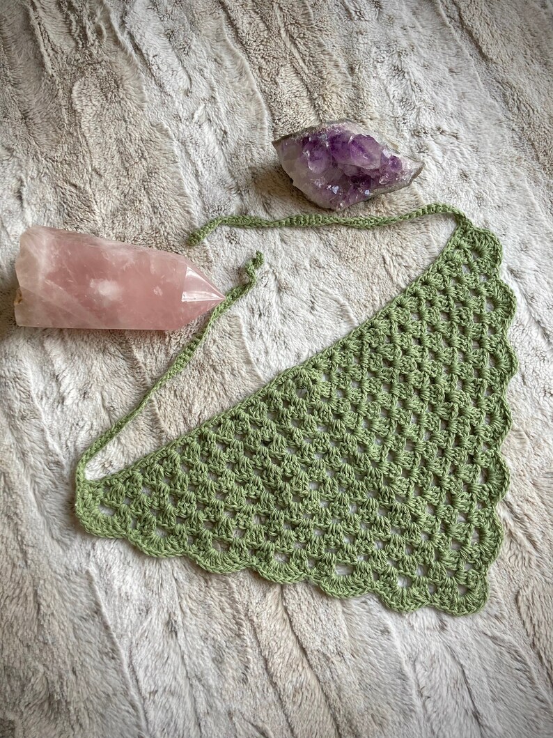 Detailed view of the handmade crochet work on the Aphrodite Shell Hair Bandana, highlighting the fine craftsmanship and unique shell edge. The color option is Sage, a solid sage green with matching edges and ties.