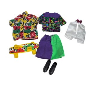 May include: A collection of doll clothing and accessories including a short-sleeve shirt with a multi-coloured abstract pattern, a purple and green skirt, a patterned top, a white vest with a small bow, a plastic skateboard, and black shoes.