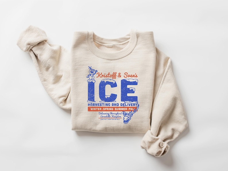 May include: Cream-colored sweatshirt with the text "Kristoff & Sven's ICE" in blue and red. The graphic includes a snowman and reindeer, with the words "Harvesting and Delivery" and "Winter-Spring-Summer-Fall".