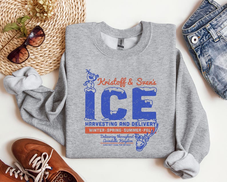 May include: A heather gray sweatshirt with the text "Kristoff & Sven's ICE" in blue and orange. The sweatshirt also features a graphic of Olaf and Sven, with the words "Harvesting and Delivery" and "Winter, Spring, Summer, Fall."