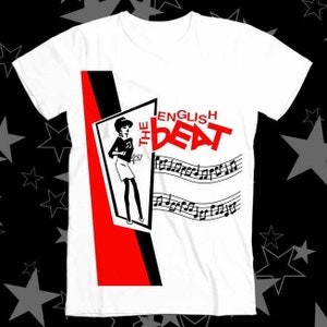 May include: White t-shirt with a black and red design featuring a woman in a skirt and the text "The English Beat".