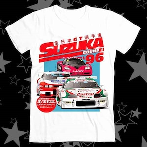 May include: White t-shirt with a graphic of race cars and the text "SUZUKA ROUND 1 '96". The design incorporates red, pink, white, and green, with Japanese text and the date 3/31.